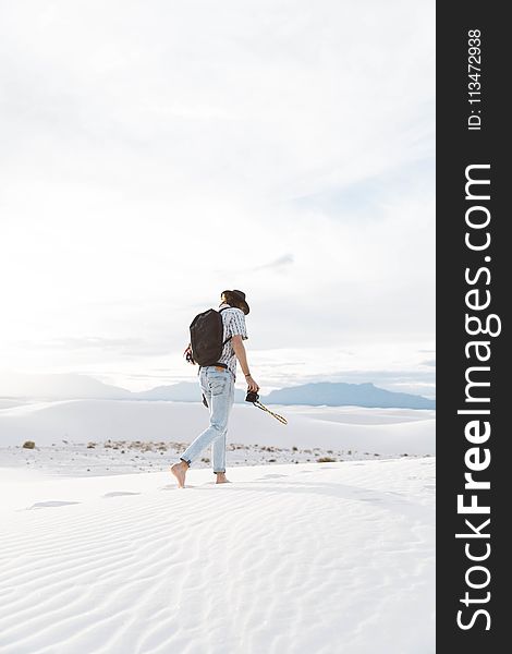 Photo Of Person Walking Along Seashore