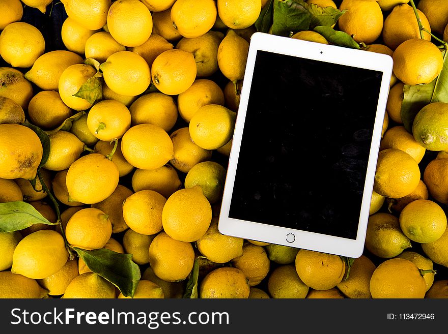 Photo of Ipad on Pile of Lemons