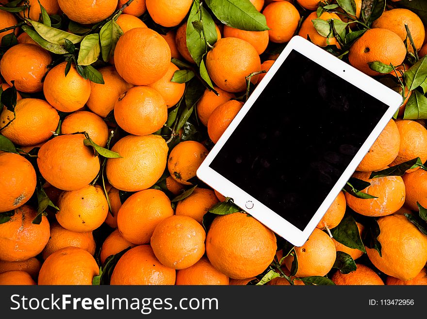 Photo of Ipad on Orange Fruits