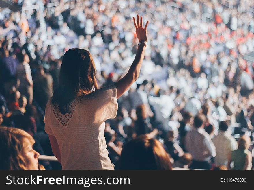 Woman With White Shirt Raising Her Right Hand