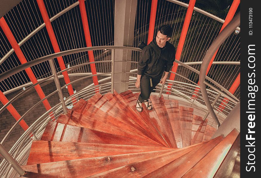 Man Wearing Black Hoodie Standing On Staircase