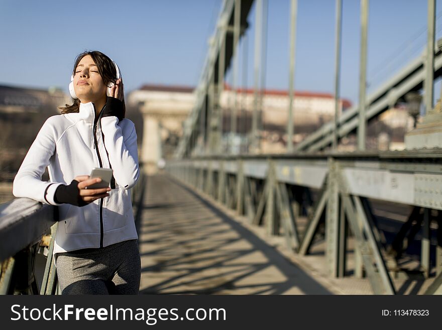 Woman On The Bridge Making A Pause After The Exercise