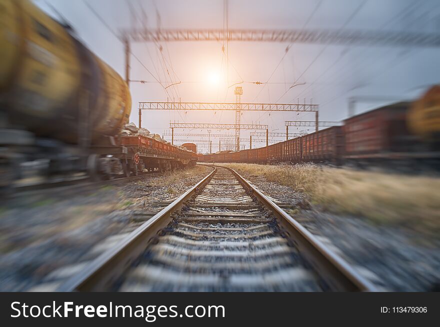 Tanks with gas or oil transportation by railroad at sunset