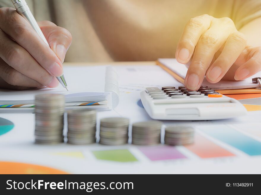 Man Using Calculator With Stock Financial Indices With Stack Coin. Financial Stock Market In Accounting Market Economy Analysis.