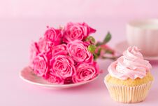 Cupcake With Pink Cream Decoration And Roses On Pink Pastel Background. Royalty Free Stock Image Cupcake With Pink Cream Decoration And Roses On Pink Pastel Background. Royalty Free Stock Image