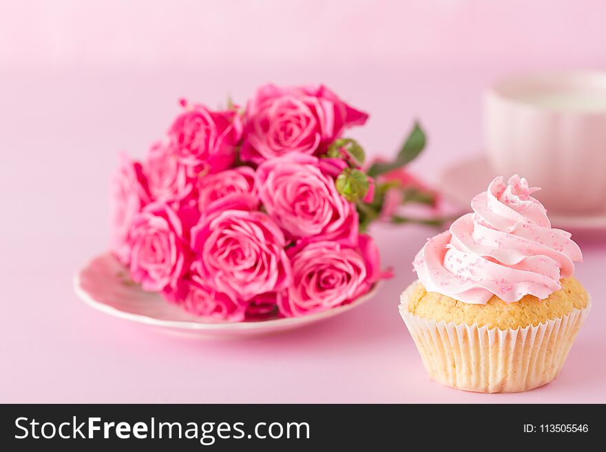 Cupcake with pink cream decoration and roses on pink pastel background - romantic horizontal banner for congratulation, greeting card for birthday, wedding, valentine or women day. Cupcake with pink cream decoration and roses on pink pastel background - romantic horizontal banner for congratulation, greeting card for birthday, wedding, valentine or women day.