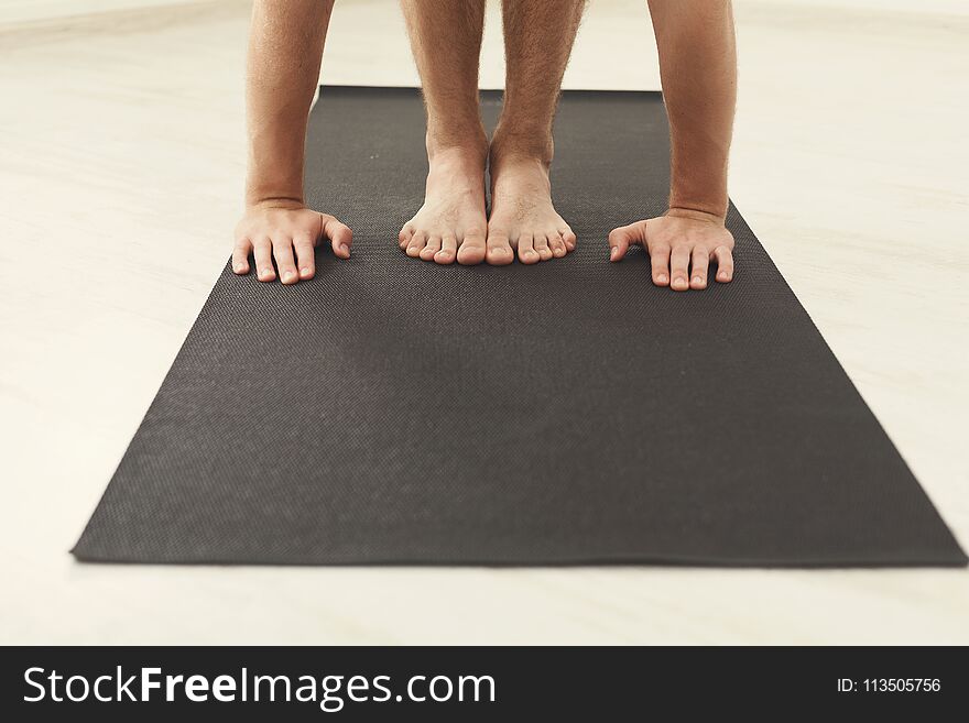 Man standing on his mat, training yoga, closeup. Fitness, meditation concept, copy space. Man standing on his mat, training yoga, closeup. Fitness, meditation concept, copy space