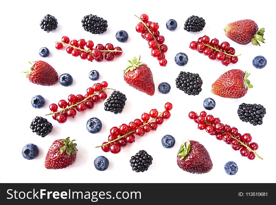 Mix berries and fruits on white background. Ripe blueberries, blackberries, strawberries and red currants. Top view. Black-blue an