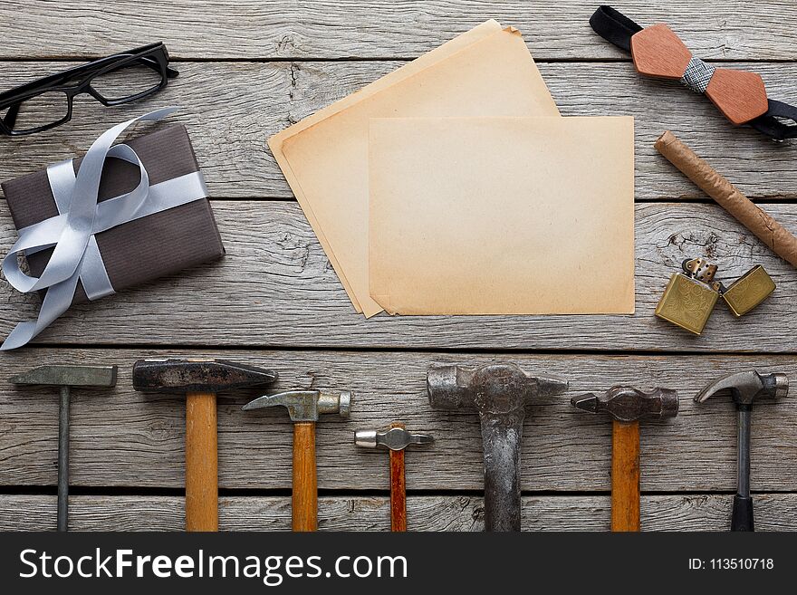 Happy Fathers Day background, card with repair tools, hammers and other man things on rustic wood, top view, copy space on craft paper