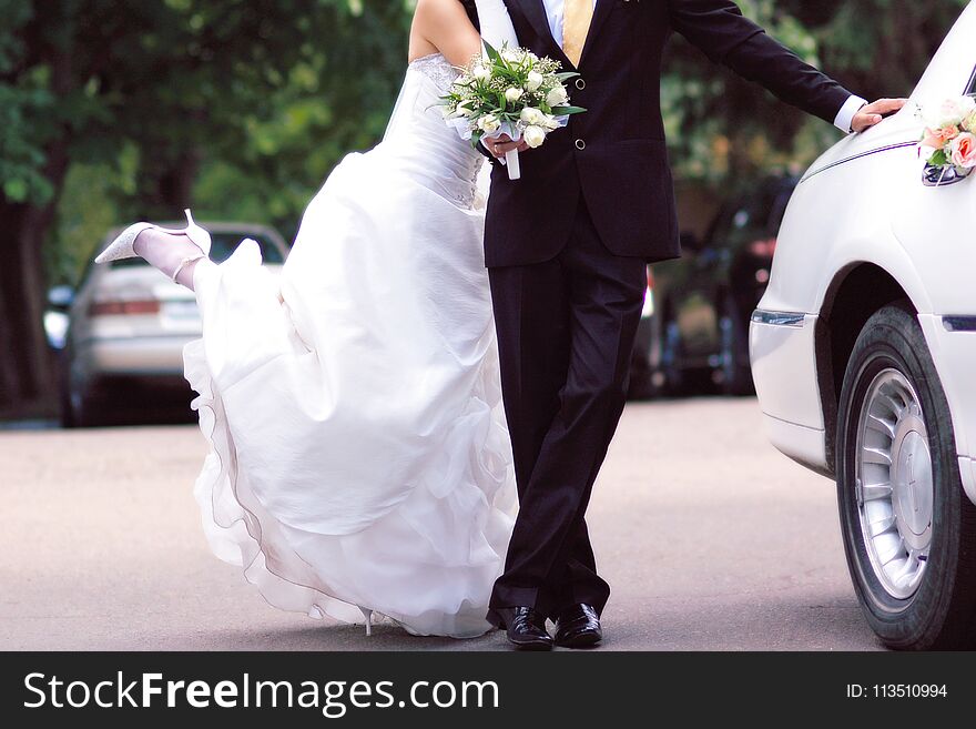 Bride And Groom Near White Limousine, Joyful