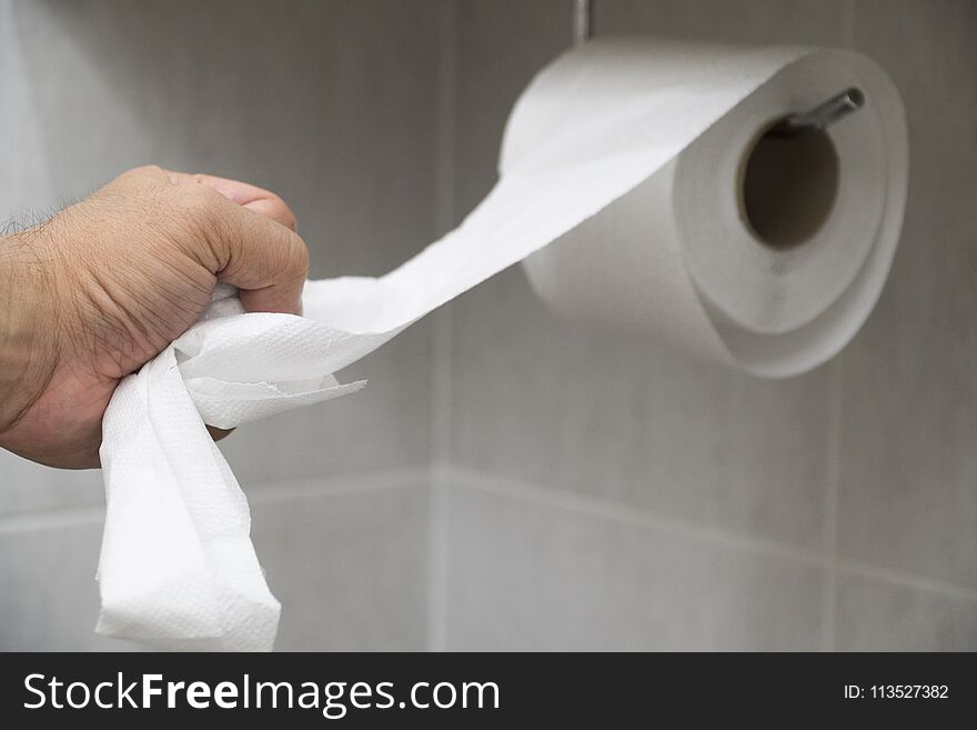 Hand picked toilet paper in the bathroom.