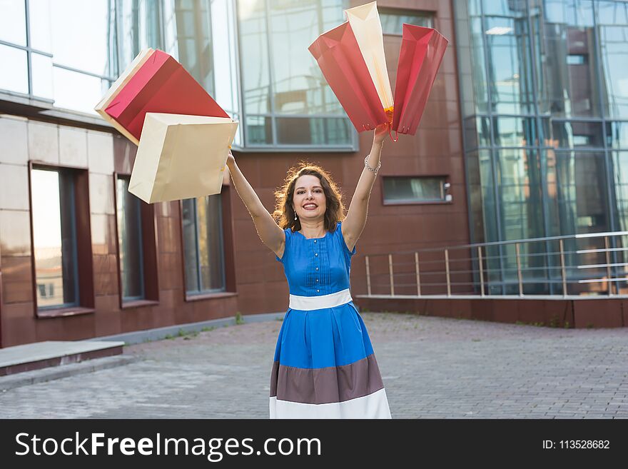 Happiness, Consumerism, Sale And People Concept - Woman With Shopping Bags