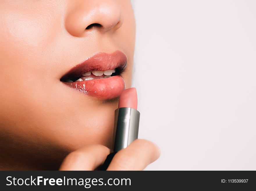 Woman Holding a Pink Lipstick