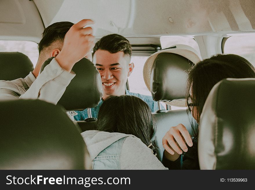 Shallow Photography of Man in Green Top Inside Vehicle