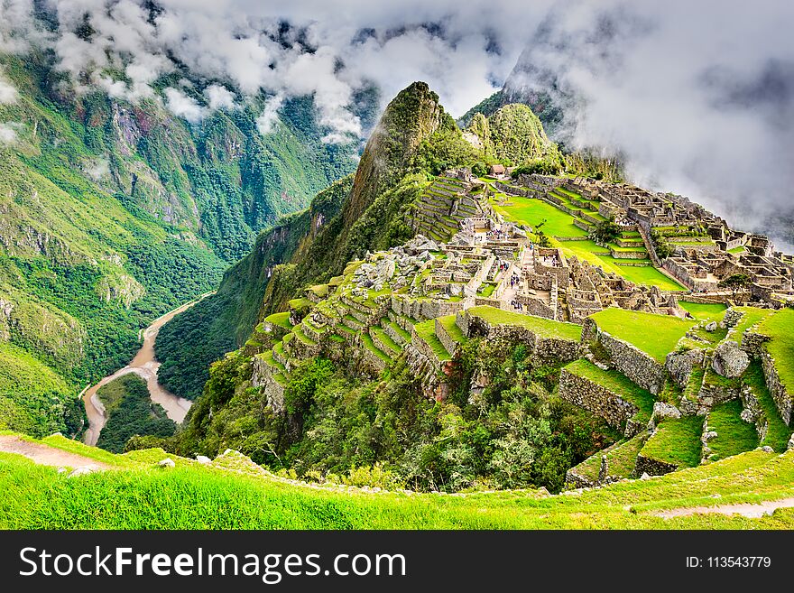 Machu Picchu in Peru - Ruins of Inca Empire city and Huaynapicchu Mountain in Sacred Valley, Cusco, South America. Machu Picchu in Peru - Ruins of Inca Empire city and Huaynapicchu Mountain in Sacred Valley, Cusco, South America.