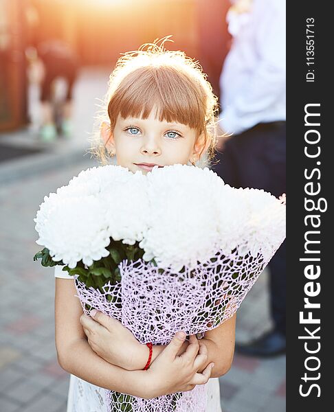 Little girl with a big bouquet of flowers