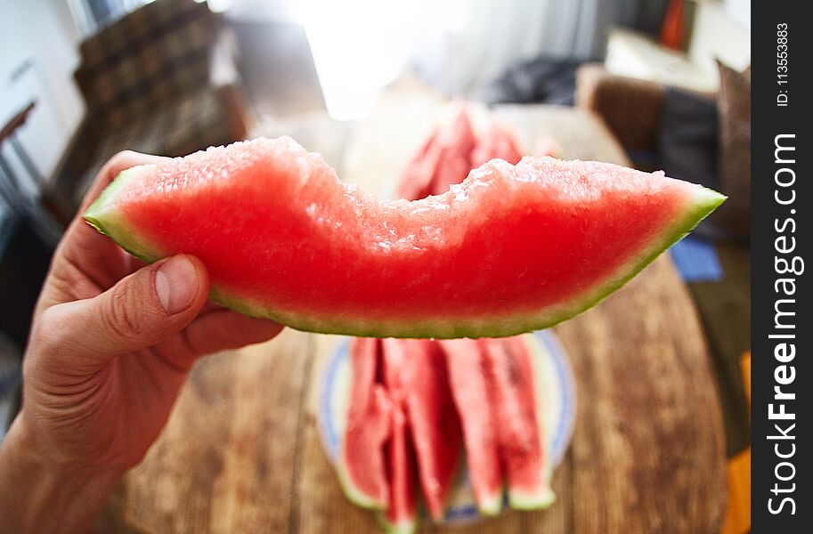 View of slice of watermelon in the hand