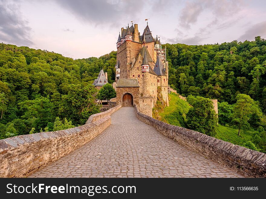 Burg Eltz castle in Rhineland-Palatinate state at sunset, Germany. Construction started	prior to 1157. Burg Eltz castle in Rhineland-Palatinate state at sunset, Germany. Construction started	prior to 1157.