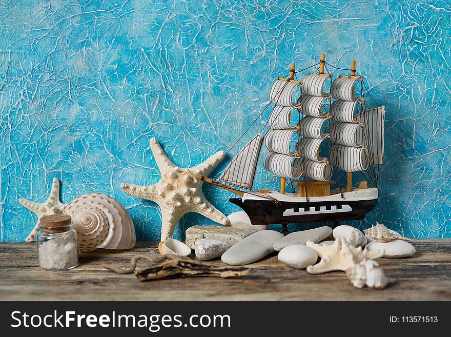 Sailboat on a blue background with sea shells