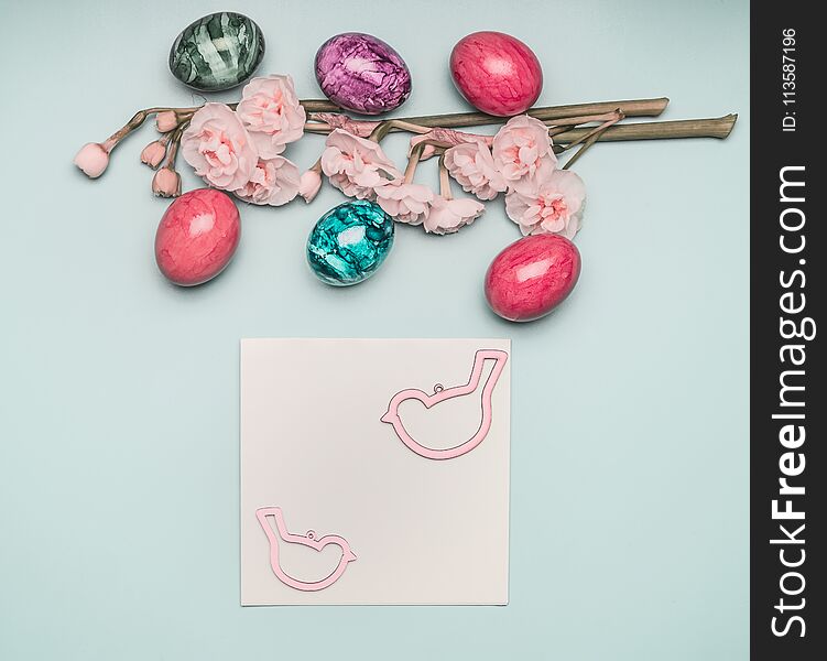 Fresh spring beautiful narcissus, with Easter eggs lined with a frame on light blue background, with a festive greeting card, space for text flat lay pastel shades. Fresh spring beautiful narcissus, with Easter eggs lined with a frame on light blue background, with a festive greeting card, space for text flat lay pastel shades