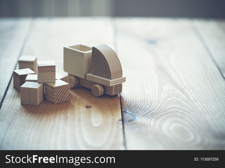 Wooden model of truck loading freight. Shipping and delivery concept