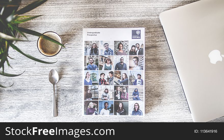 Flat Lay Photography of Cup, Spoon, Macbook and Book