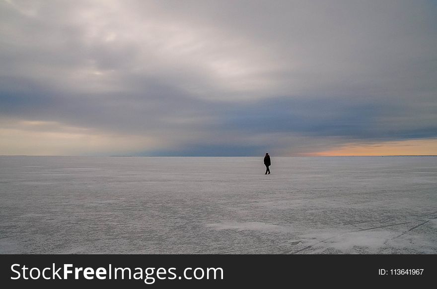 Silhouette of Person Walking on Vast Land