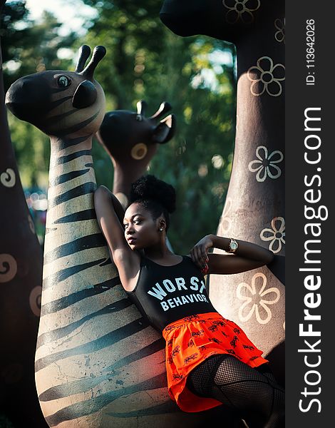 Woman Leaning On Zebra Statue