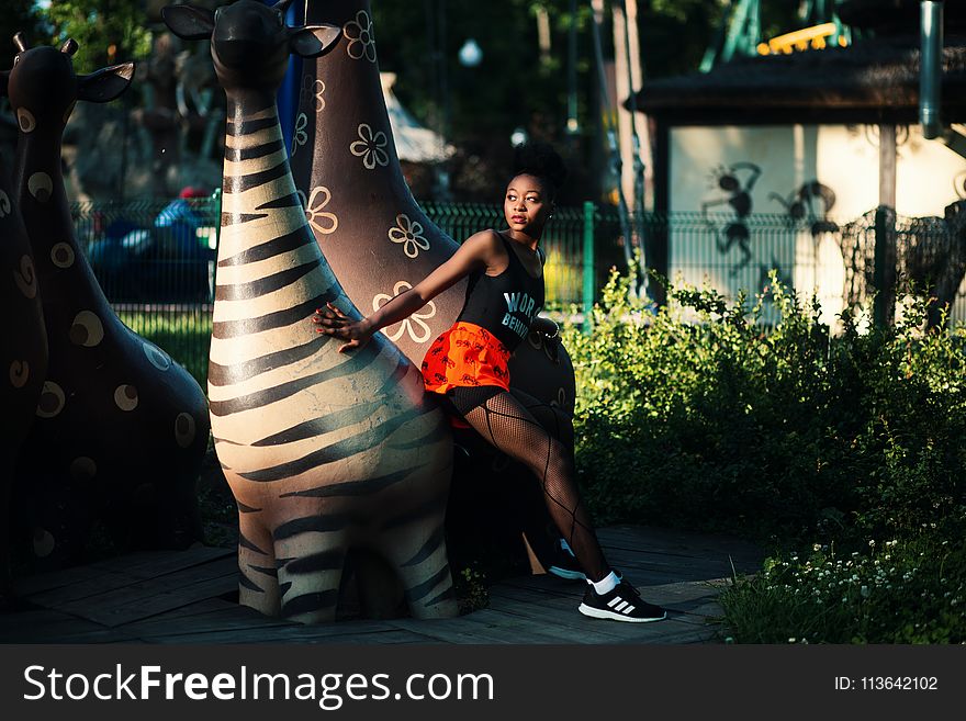 Photo of Woman Beside Zebra Statue
