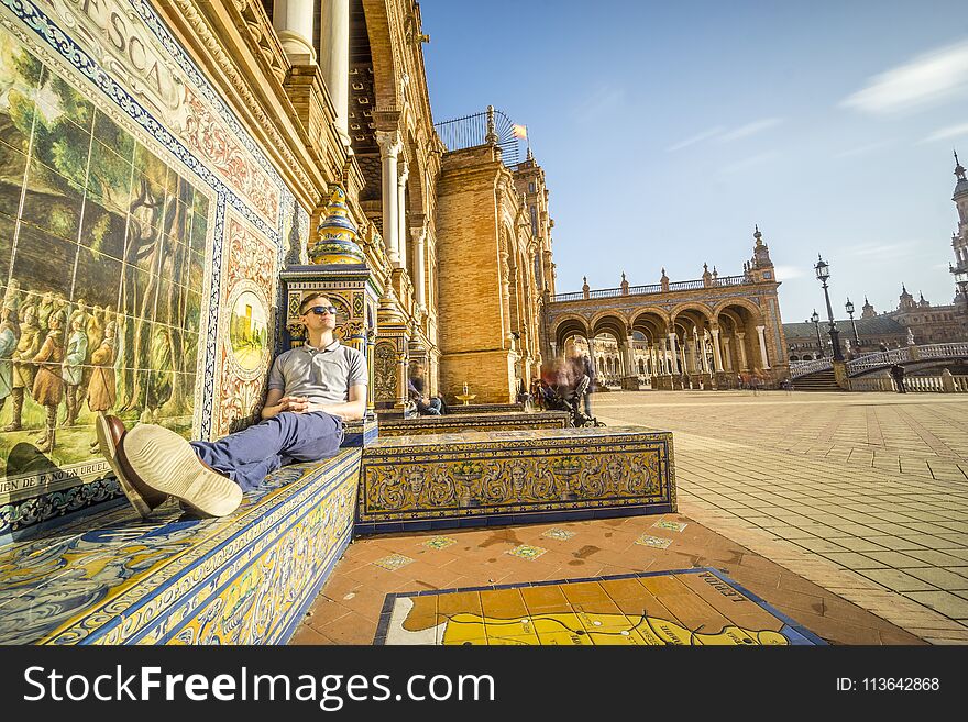 Tourist enjoying sun on Plaza de Espana, Seville, Andalusia, Spa