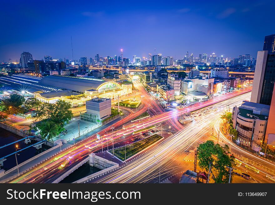 Bangkok railway station Hua Lamphong with lights of cars at twilight in Bangkok, Thailand.