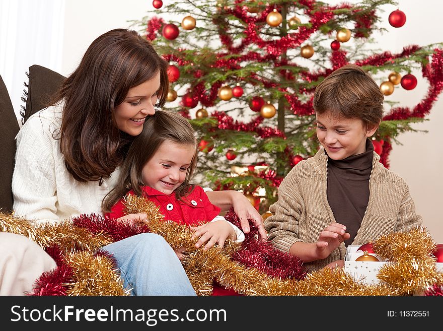 Happy family: mother with son and daughter on Christmas. Happy family: mother with son and daughter on Christmas