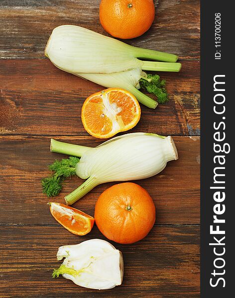 Fennel Vegetable Isolated. Fennel and Orange Citrus Fruit over Wooden Background. Healthy Vegetarian Food.