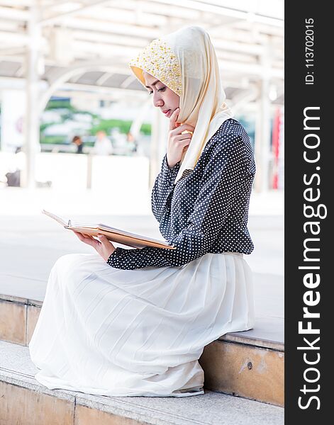 Muslim lady reading the book