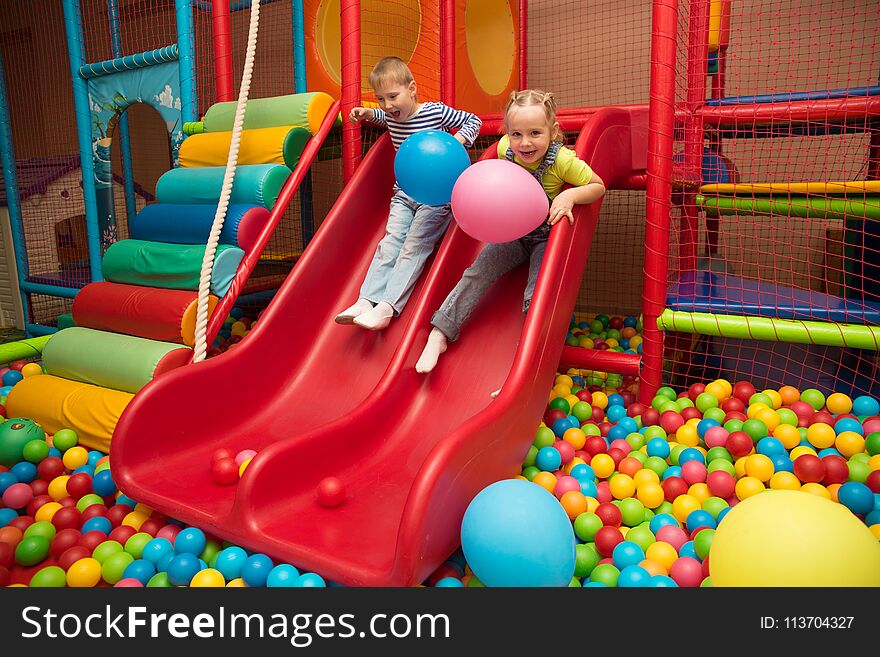 Kids playing in a pool of balls