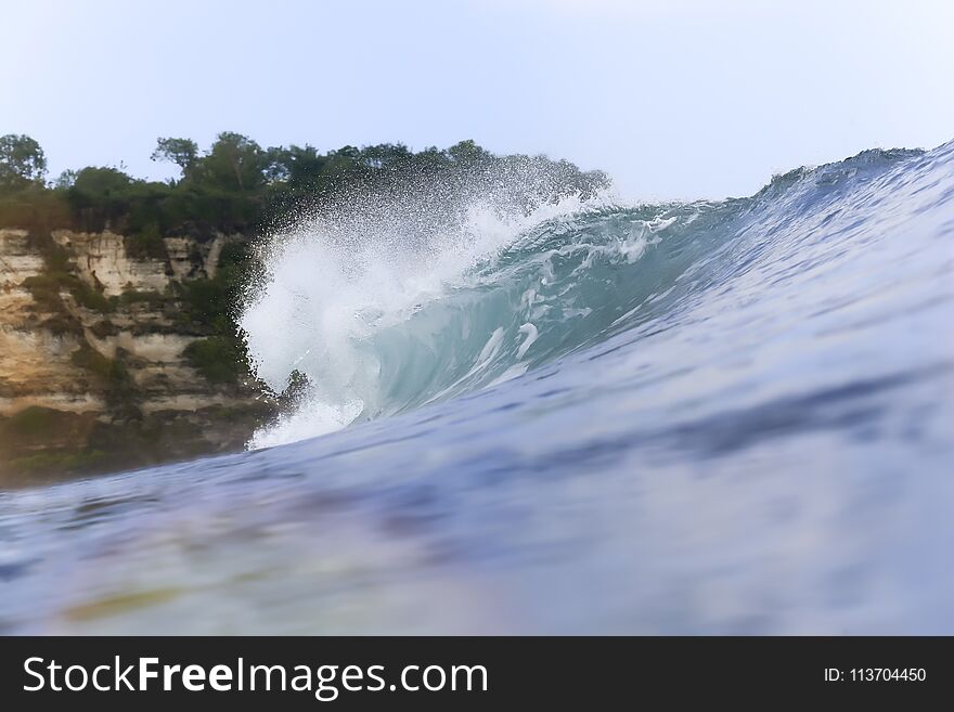 Blue ocean wave. View form water. Uluwatu. Bali. Indonesia. Blue ocean wave. View form water. Uluwatu. Bali. Indonesia