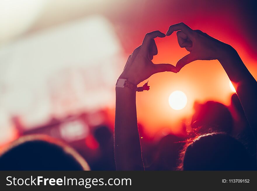 Cheering Crowd With Hands In Air At Music Festival