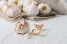 Garlic Bulbs With Garlic Cloves With Canvas On White Wood. Royalty Free Stock Photography