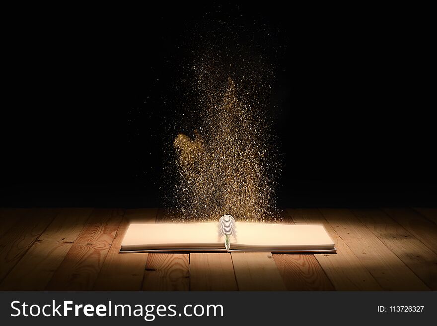 Magic book on wooden floor