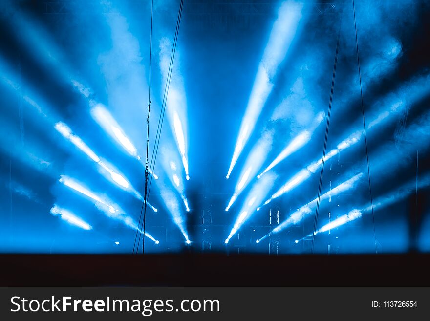 The light rays from the spotlight through the smoke. Lighting equipment on the ceiling. The stage of a theatre or night club. Show or performance. The light rays from the spotlight through the smoke. Lighting equipment on the ceiling. The stage of a theatre or night club. Show or performance.