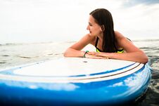 Female Surfer Paddling On Surfboard To The Open Sea Royalty Free Stock Images