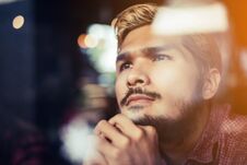 Pensive Young Hipster Man Sitting In Coffee Shop Thinking And Lo Stock Photos