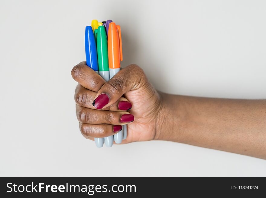 African American woman with markers in her hand at a school. African American woman with markers in her hand at a school
