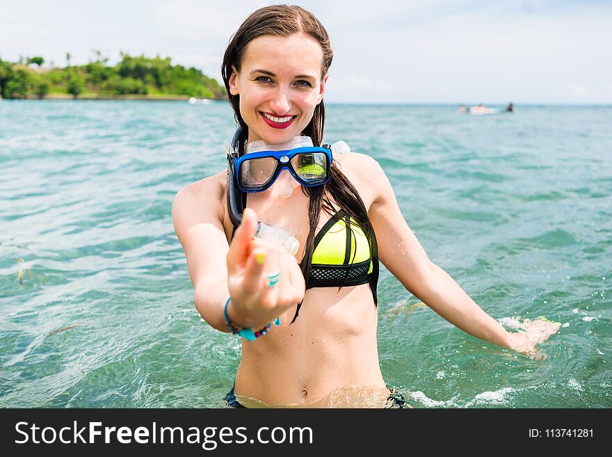 Woman With Snorkelling Equipment Standing In Ocean