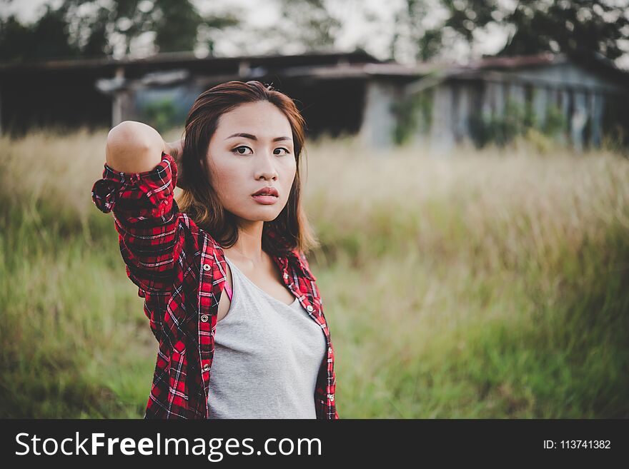 Young beautiful woman walking through in summer field, Freedom e