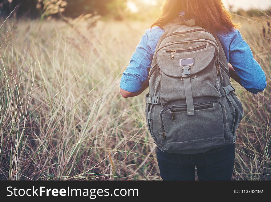 Vintage Tone Images Of Beautiful Young Hipster Woman With Backpack Walking On Meadow. Portrait Of Hiker Girl Outdoor.