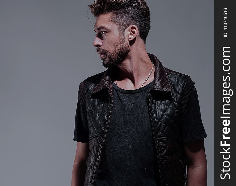 Portrait of a pensive handsome man over gray background