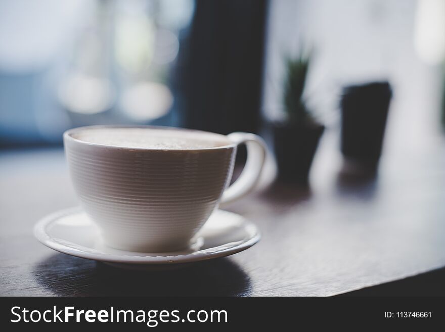 Coffee cup at cafe with vintage filter background. Coffee cup at cafe with vintage filter background