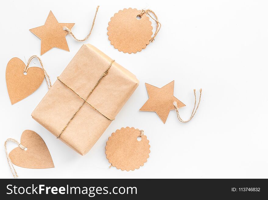 Parcel packaging box wrapped with craft paper with empty label mockup on whitebackground top view copy space