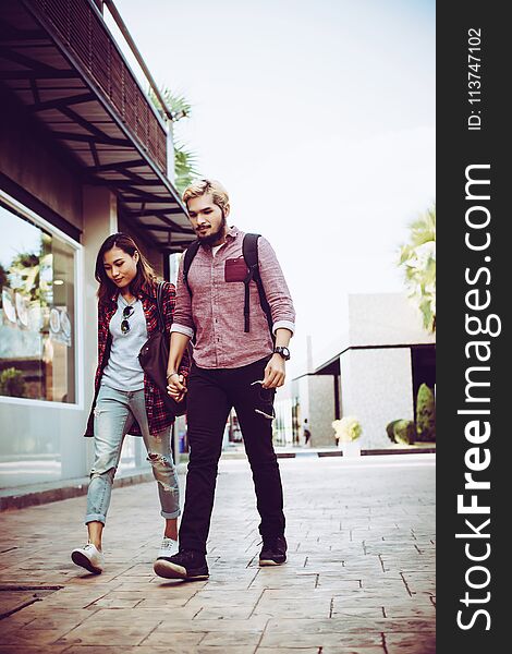 Portrait of hipster couple walking in the street urban. Couple enjoy the time together.